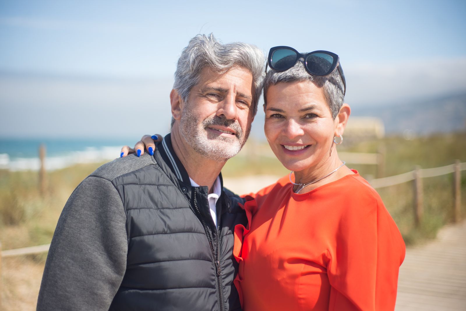 Retired couple smiling together at the beach